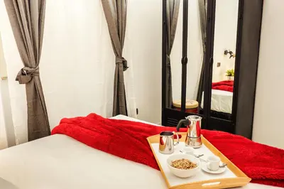 a tray of food on a bed with a mirror at BMGA l Stylish Industrial Termini Apartment in Rome