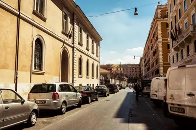 a row of cars parked on a city street at BMGA l Stylish Industrial Termini Apartment in Rome