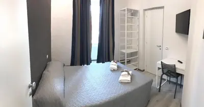 a bedroom with a bed with towels on it at Sangiò Guest House in Rome