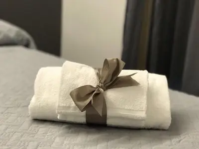 a pile of towels with a bow on a bed at Sangiò Guest House in Rome