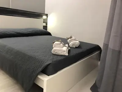 a bed with two towels sitting on top of it at Sangiò Guest House in Rome