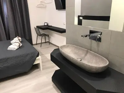 a bathroom with a sink and a bed at Sangiò Guest House in Rome
