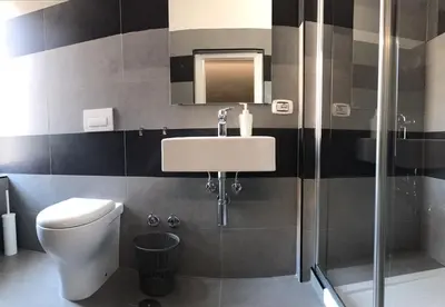 a bathroom with a toilet and a sink and a shower at Sangiò Guest House in Rome