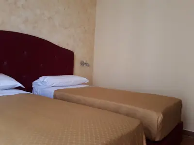 a bedroom with two beds and a headboard at Clodio Rooms in Rome