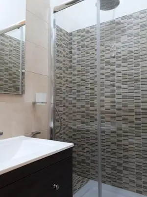 a bathroom with a sink and a glass shower at Clodio Rooms in Rome