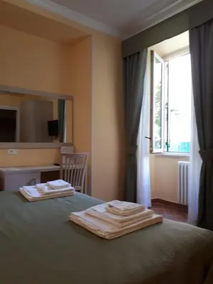 a bedroom with a bed with two towels on it at Clodio Rooms in Rome