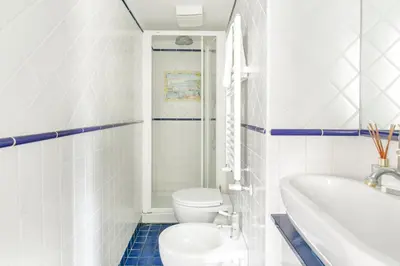 a bathroom with a toilet and a tub and a sink at Leopardo 28 - Loft in Trastevere in Rome