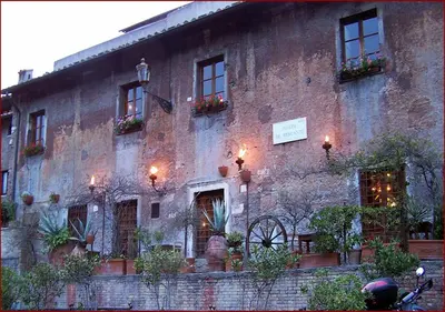 an old brick building with windows and lights on it at Leopardo 28 - Loft in Trastevere in Rome