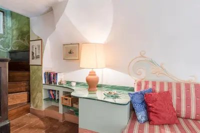 a white bedroom with a bed and a table at Piazza Colonna Apartment - Charme Holidays in Rome