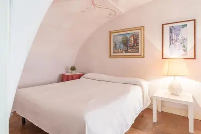 a bedroom with a white bed and red walls at Piazza Colonna Apartment - Charme Holidays in Rome
