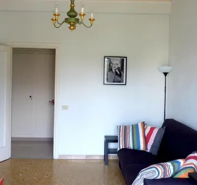 a living room with a couch and a picture on the wall at Tommy Guest House Roma in Rome