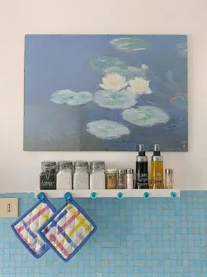 a shelf in a bathroom with bottles and a painting at Tommy Guest House Roma in Rome