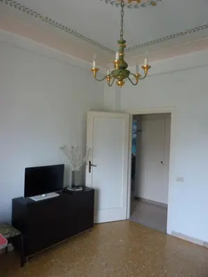 a living room with a couch and a chandelier at Tommy Guest House Roma in Rome