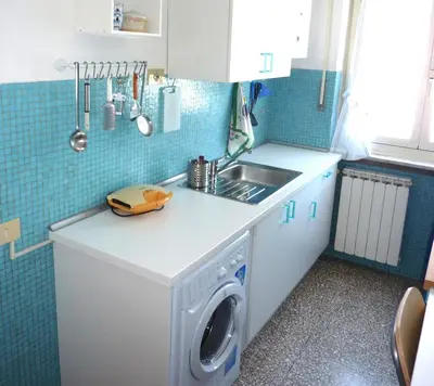 a kitchen with a washing machine and a sink at Tommy Guest House Roma in Rome