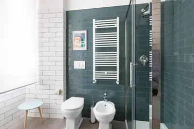 a bathroom with a toilet and a glass shower at Lata Luxury Penthouse in Rome