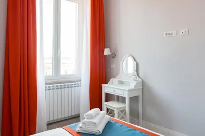 a bedroom with a bed and a mirror and a sink at Lata Luxury Penthouse in Rome