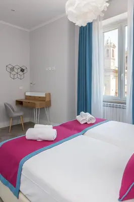 a bedroom with a bed and a desk and a window at Lata Luxury Penthouse in Rome