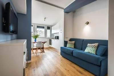 a living room with a blue couch and a table at Expeditus VATICAN Luxury Suites SAINT PETER'S VIEW in Rome