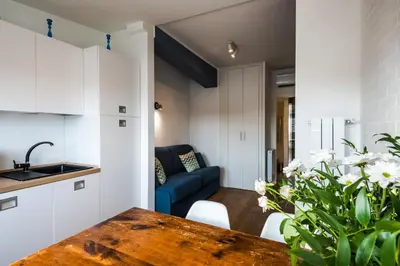 a kitchen and living room with a table and a couch at Expeditus VATICAN Luxury Suites SAINT PETER'S VIEW in Rome