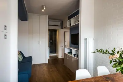 a living room with a blue couch and a table at Expeditus VATICAN Luxury Suites SAINT PETER'S VIEW in Rome