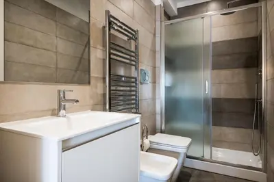 a bathroom with a sink and a shower and a toilet at Expeditus VATICAN Luxury Suites SAINT PETER'S VIEW in Rome