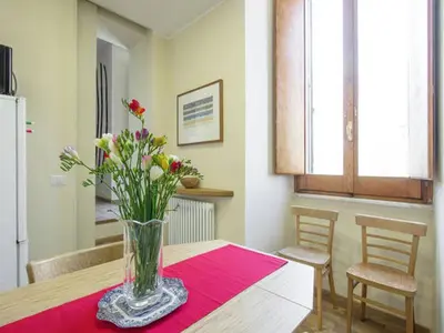 a vase of flowers sitting on a table in a kitchen at Al Portico 39 Apartment in Rome