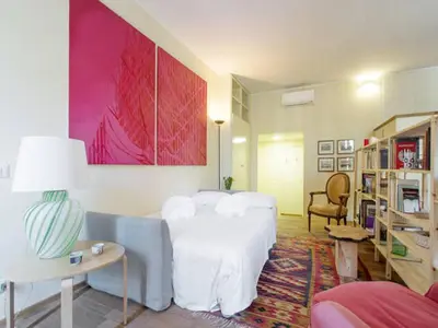 a living room with a bed and a couch at Al Portico 39 Apartment in Rome