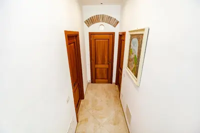 a hallway with two doors and a painting on the wall at Stop Colosseo in Rome