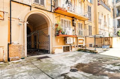 an alley in an old building with an open gate at Stop Colosseo in Rome