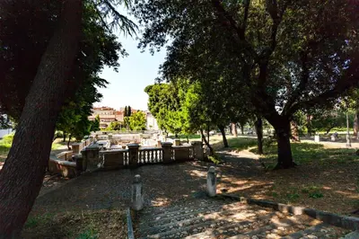 a park with trees and a stone path at Stop Colosseo in Rome