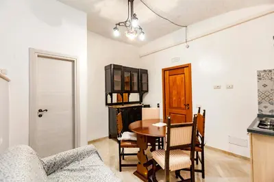 a kitchen and dining room with a table and chairs at Stop Colosseo in Rome
