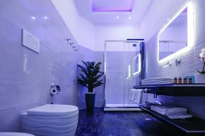 a bathroom with a toilet and a plant in it at Escape Luxury Suite - CA Domus Collection in Rome