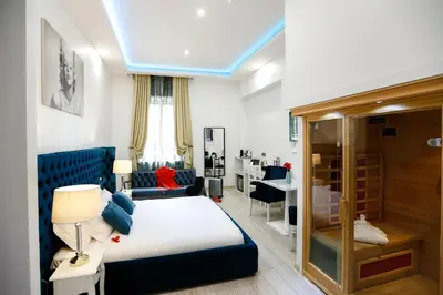 a hotel room with a bed and a desk at Escape Luxury Suite - CA Domus Collection in Rome