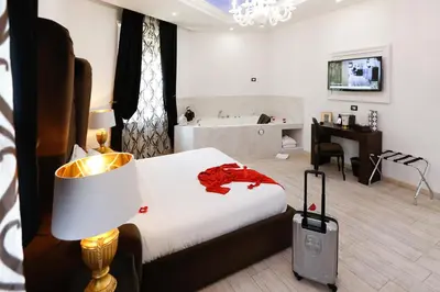 a hotel room with a bed and a desk and a room at Escape Luxury Suite - CA Domus Collection in Rome