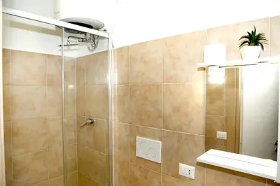 a bathroom with a toilet and a sink at Gateway Residence in Rome