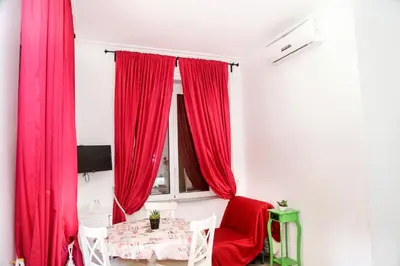 a bedroom with a red bed with two white towels at Gateway Residence in Rome