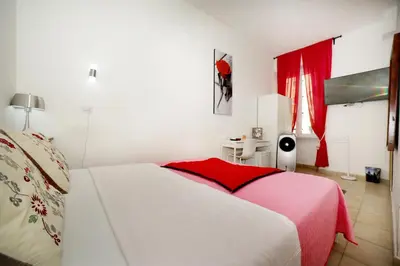 a bedroom with a white bed with a red blanket at Gateway Residence in Rome