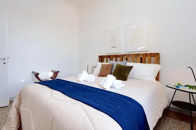 a bedroom with a large bed with a blue blanket at Piazza Capponi Apartment in Rome