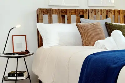 a bedroom with a bed with a wooden headboard at Piazza Capponi Apartment in Rome