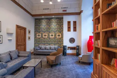 a living room with two couches and a tv at Hotel Damaso in Rome