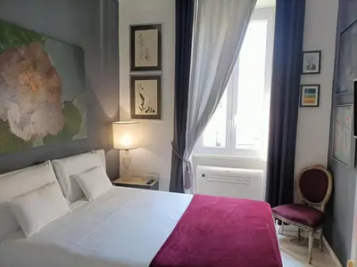 a bedroom with a white bed and a window at Luca's Vatican Hospitality in Rome