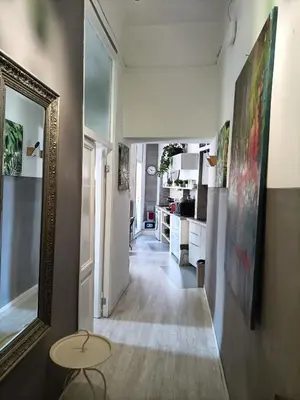 a hallway of a kitchen with a table and a mirror at Luca's Vatican Hospitality in Rome