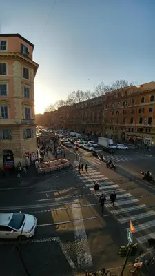 a city street with people and cars and buildings at Luca's Vatican Hospitality in Rome
