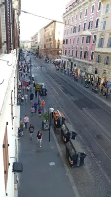 a group of people walking down a city street at Luca's Vatican Hospitality in Rome
