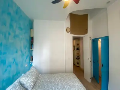 a bedroom with a bed and a ceiling fan at CASA CENEDA 46 in Rome
