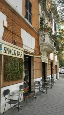a row of tables and chairs outside of a snack bar at CASA CENEDA 46 in Rome