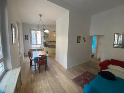 a living room and kitchen with a table and chairs at CASA CENEDA 46 in Rome
