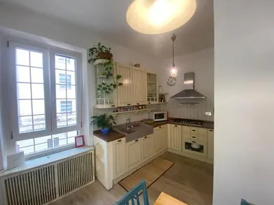 a kitchen with white cabinets and a large window at CASA CENEDA 46 in Rome