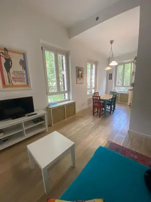 a living room with a tv and a table at CASA CENEDA 46 in Rome