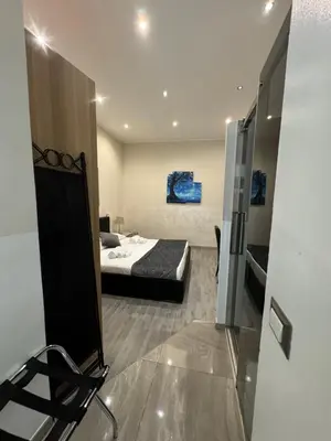 a bedroom with a bed and a mirror and a chair at RHS Rienzo Suites in Rome